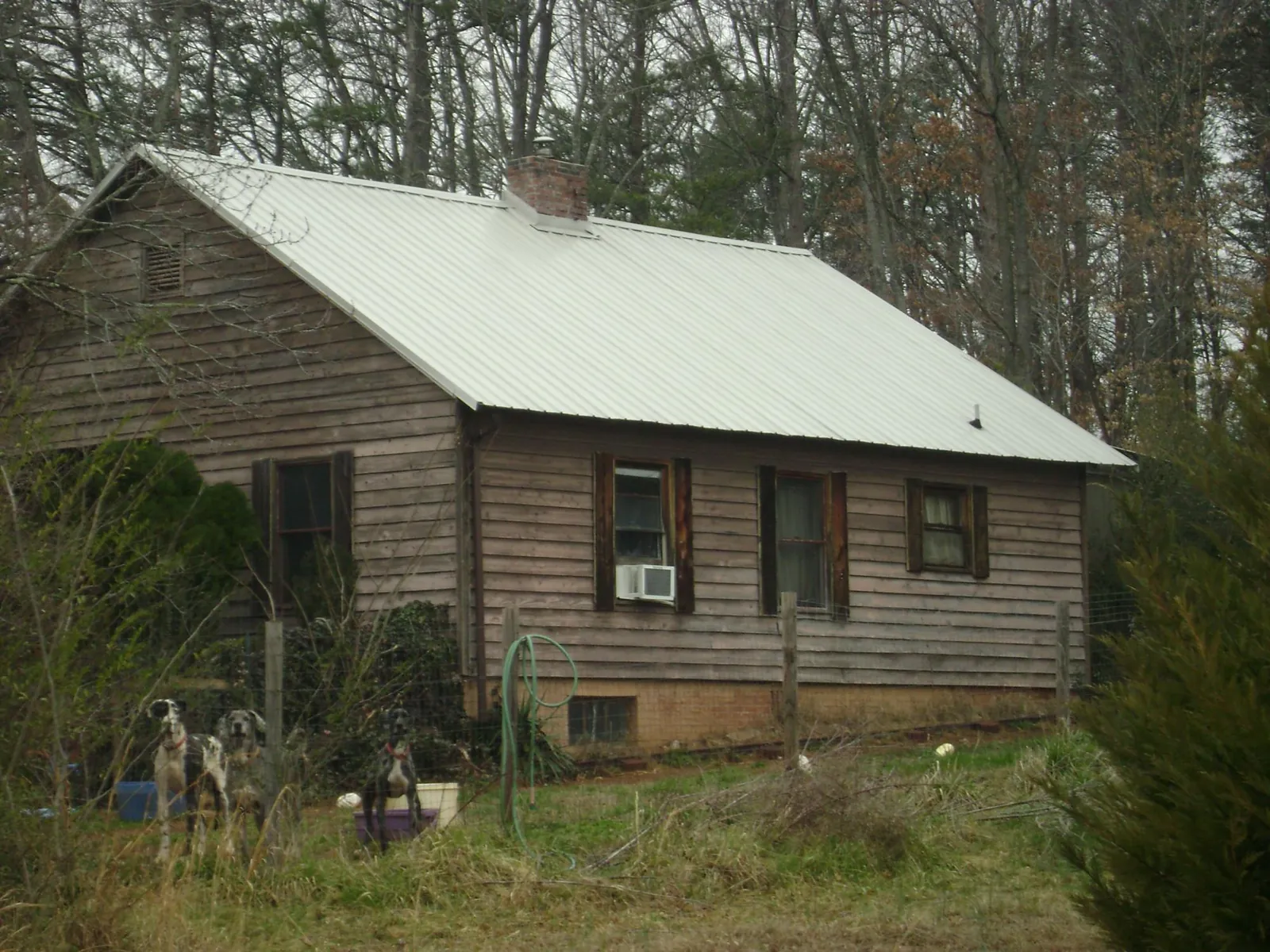 White metal roof on an old wood sided farmhouse, from a Metal Roof Installation job in Brookfield